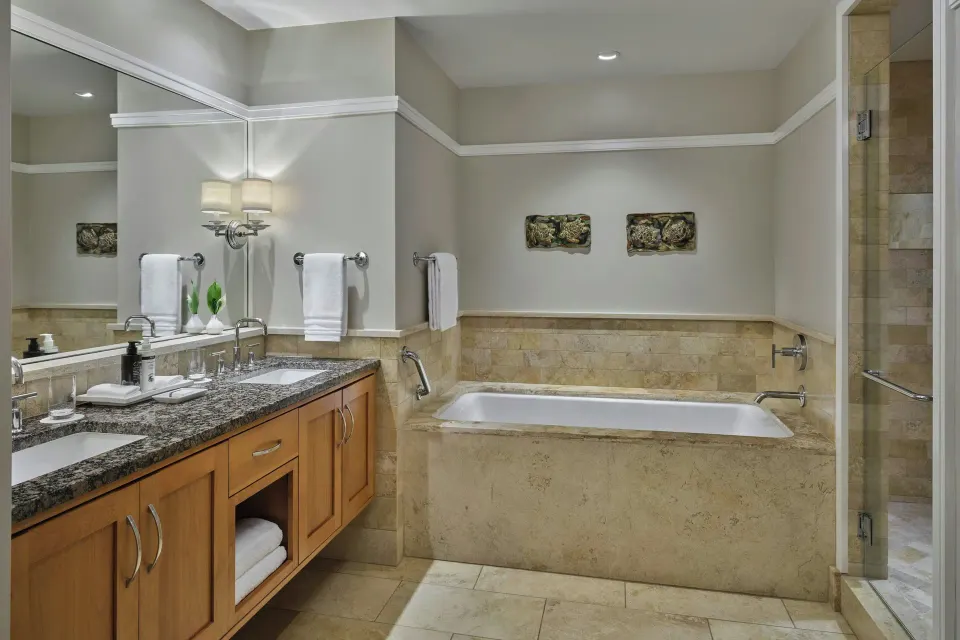 Bathroom with tub and granite vanity at The Resort at Kapalua Bay, Maui
