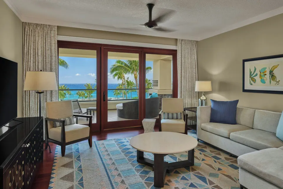 Living room with sofa and ocean-view lanai at The Resort at Kapalua Bay, Maui