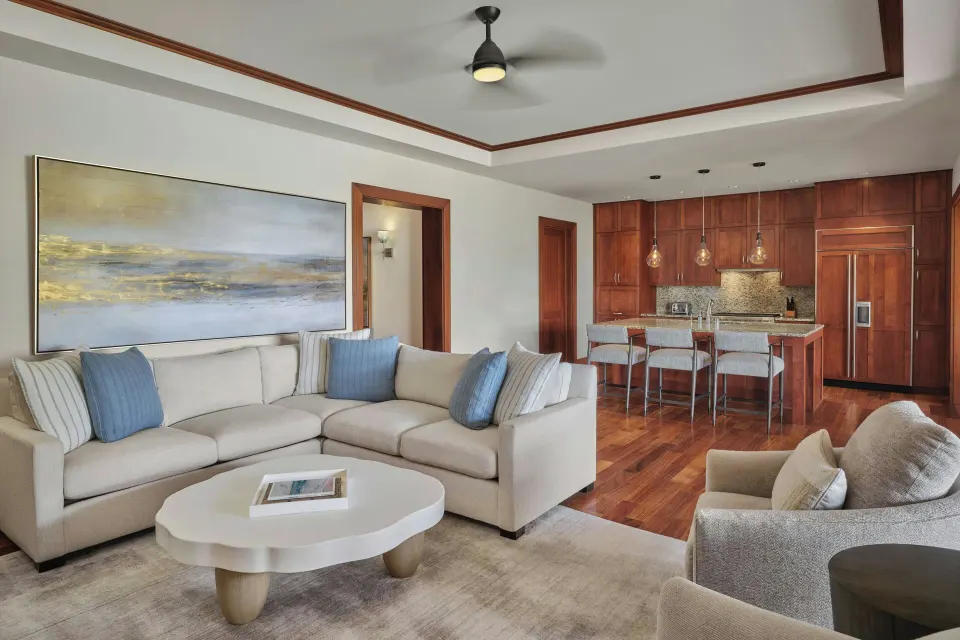 Signature 3 Bedroom Residence living room with sofa and kitchenette at The Resort at Kapalua Bay, Maui