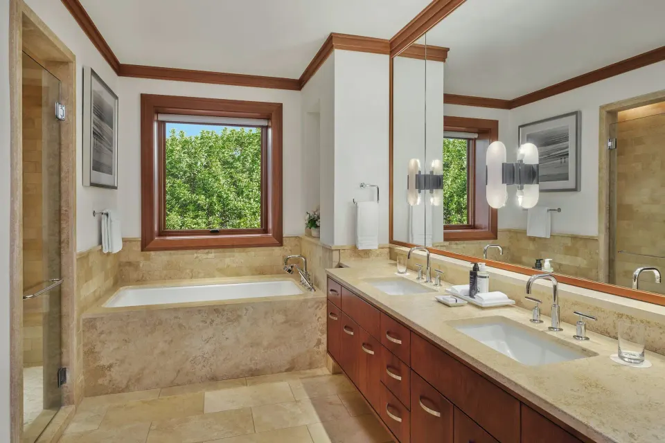 Master bathroom vanity with dual sinks and marble tub at The Resort at Kapalua Bay, Maui