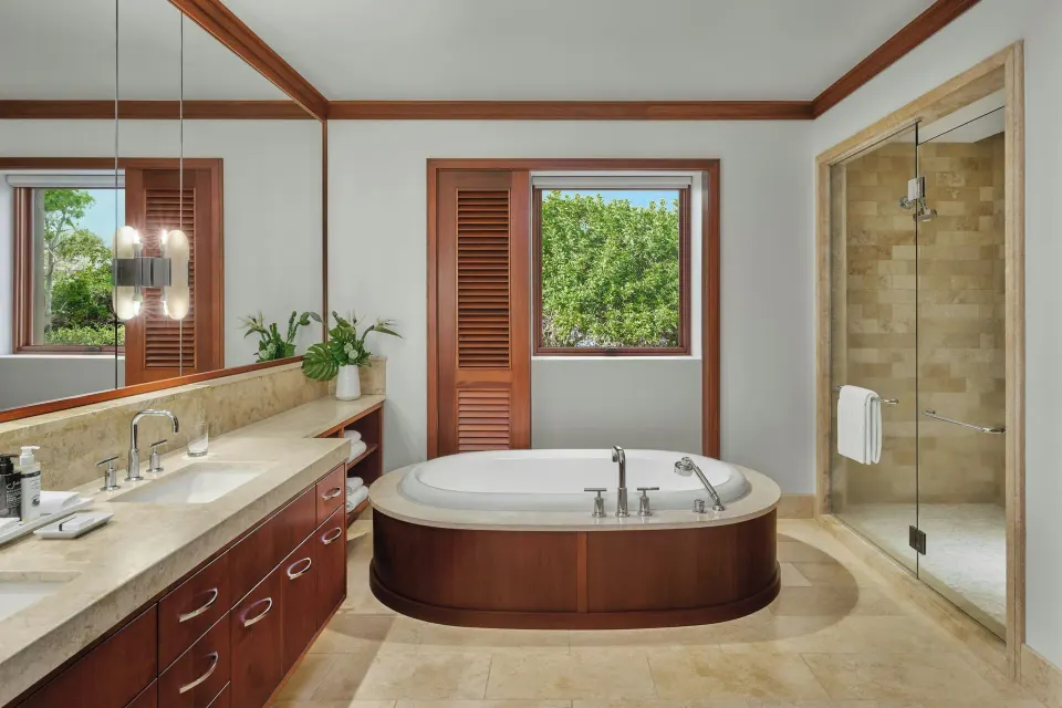 Master bathroom with freestanding tub and glass shower at The Resort at Kapalua Bay, Maui