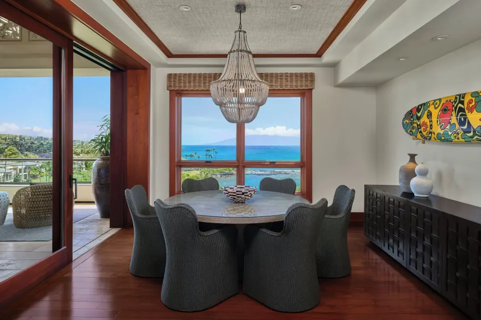 Dining area with chandelier and ocean window in Signature 3 Bedroom Residence at The Resort at Kapalua Bay, Maui