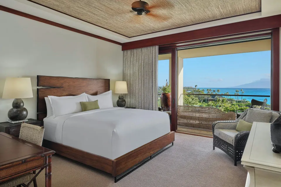 King bed and ocean view balcony in Signature 3 Bedroom Residence at The Resort at Kapalua Bay, Maui
