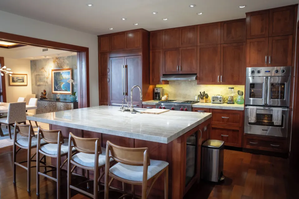 Kitchen with marble island and stools in Signature 3 Bedroom Residence at The Resort at Kapalua Bay, Maui