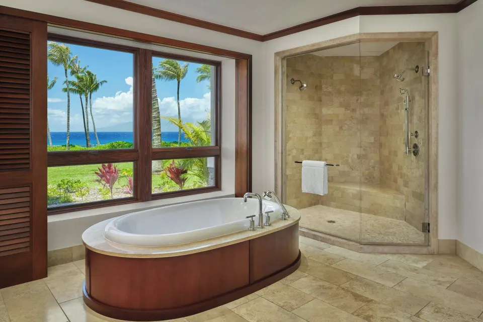 Oceanfront bathroom with freestanding tub and glass shower in a Signature 4 Bedroom Residence at The Resort at Kapalua Bay, M