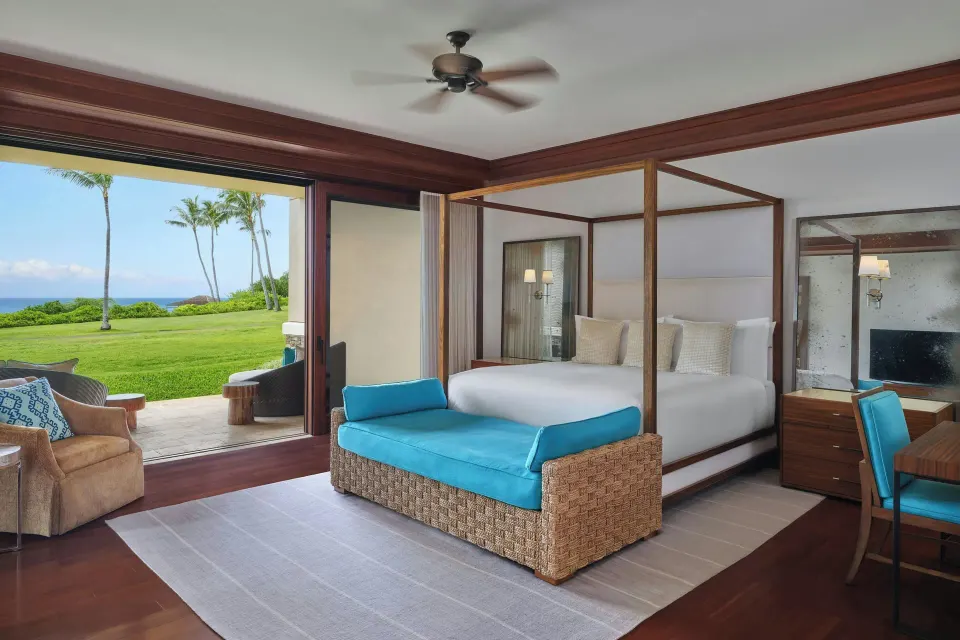 Bedroom with four-poster king bed and ocean view at The Resort at Kapalua Bay, Maui