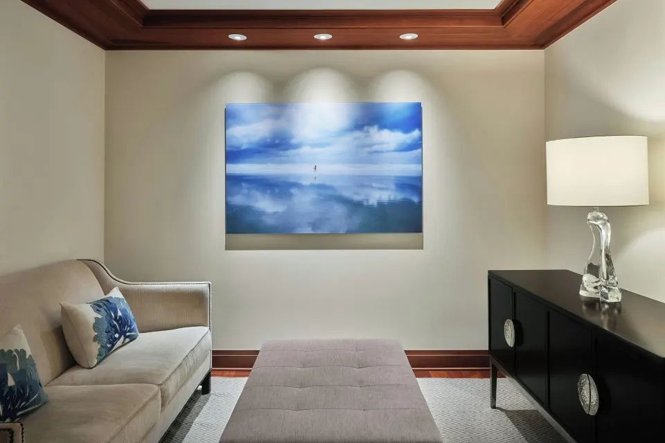 Small sitting area with sofa and wall art in residence at The Resort at Kapalua Bay, Maui
