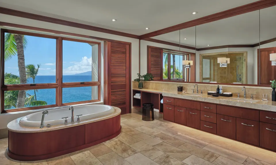 Bathroom with freestanding tub and double vanity overlooking the ocean at The Resort at Kapalua Bay, Maui