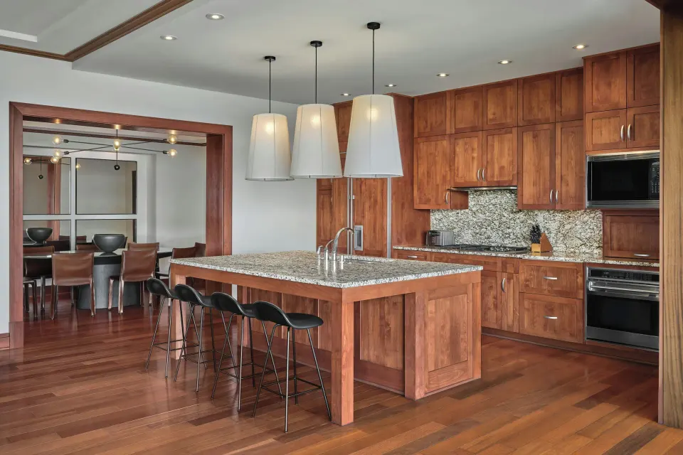 Large kitchen and dining passage with pendant lights in a Signature 4 Bedroom Residence at The Resort at Kapalua Bay, Maui