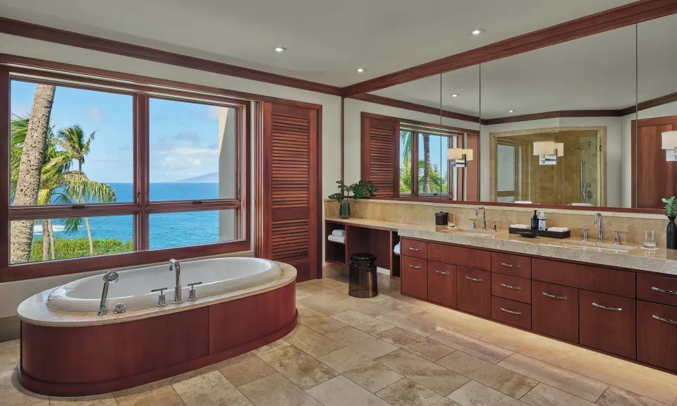 Oceanfront Laua'e bathroom with freestanding tub and double vanity at The Resort at Kapalua Bay, Maui