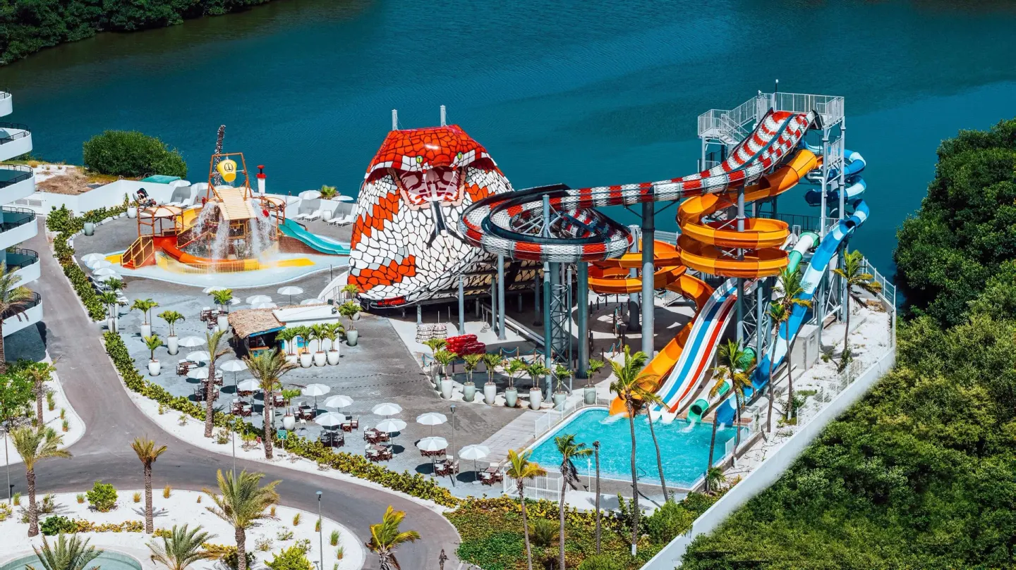 Aerial view of water slides beside a lagoon at The Rif at Mangrove Beach Corendon Curacao, Curio.