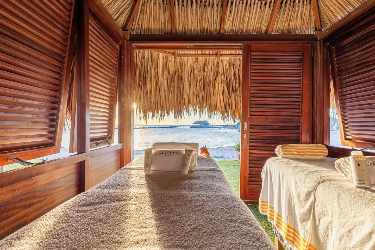 Spa treatment beds in a wooden beach cabana at The Rif at Mangrove Beach Corendon Curacao, Curio.