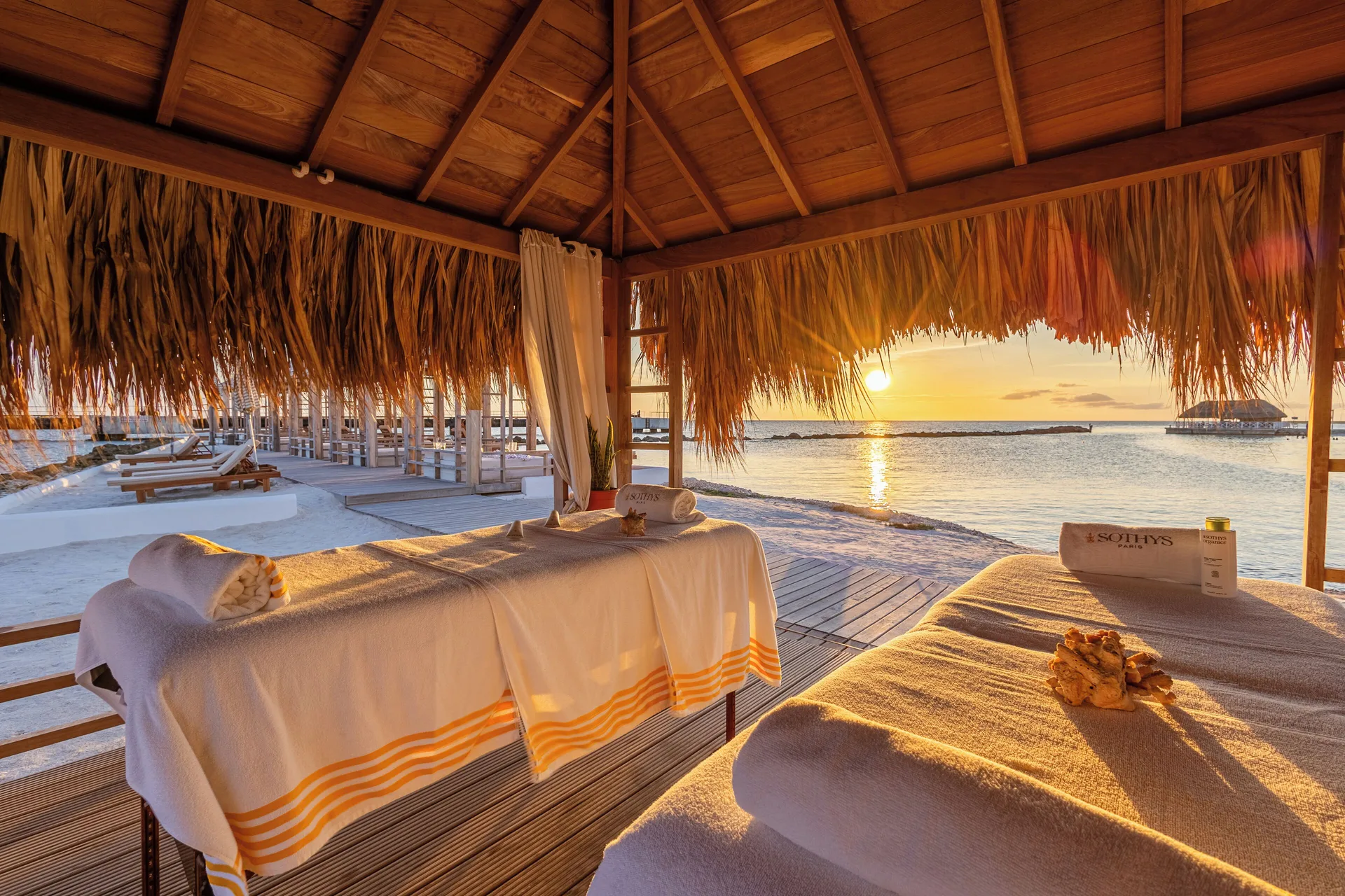 Two beachfront massage tables at sunset at The Rif at Mangrove Beach Corendon Curacao, Curio.