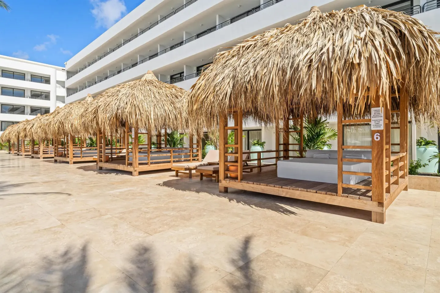 Poolside cabanas with thatched roofs at The Rif at Mangrove Beach Corendon Curacao, Curio.