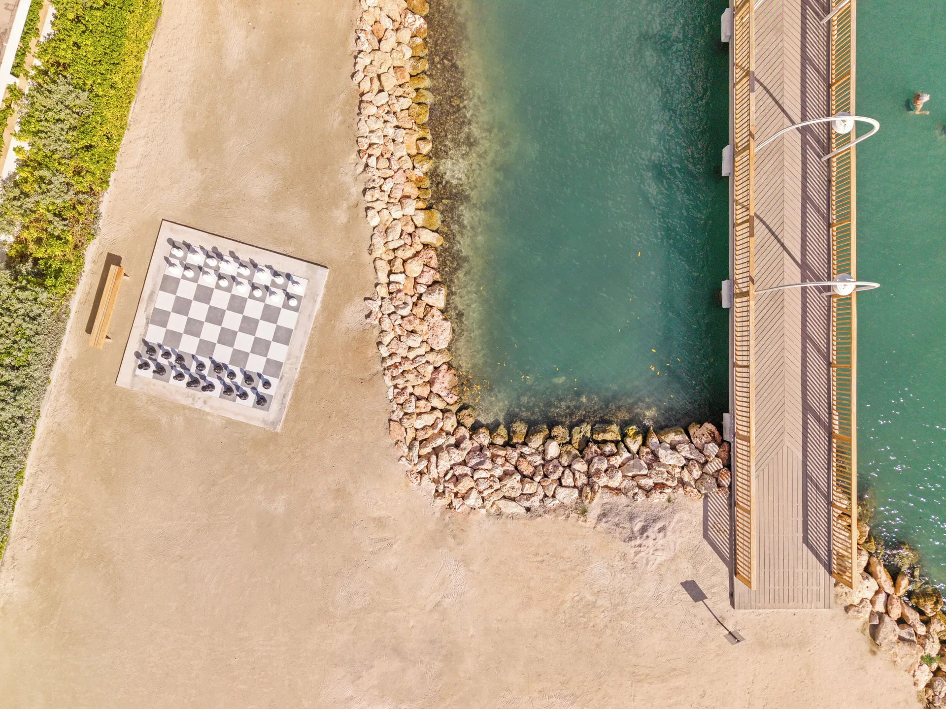 Aerial view of a seaside chess board and pier at The Rif at Mangrove Beach Corendon Curacao, Curio.