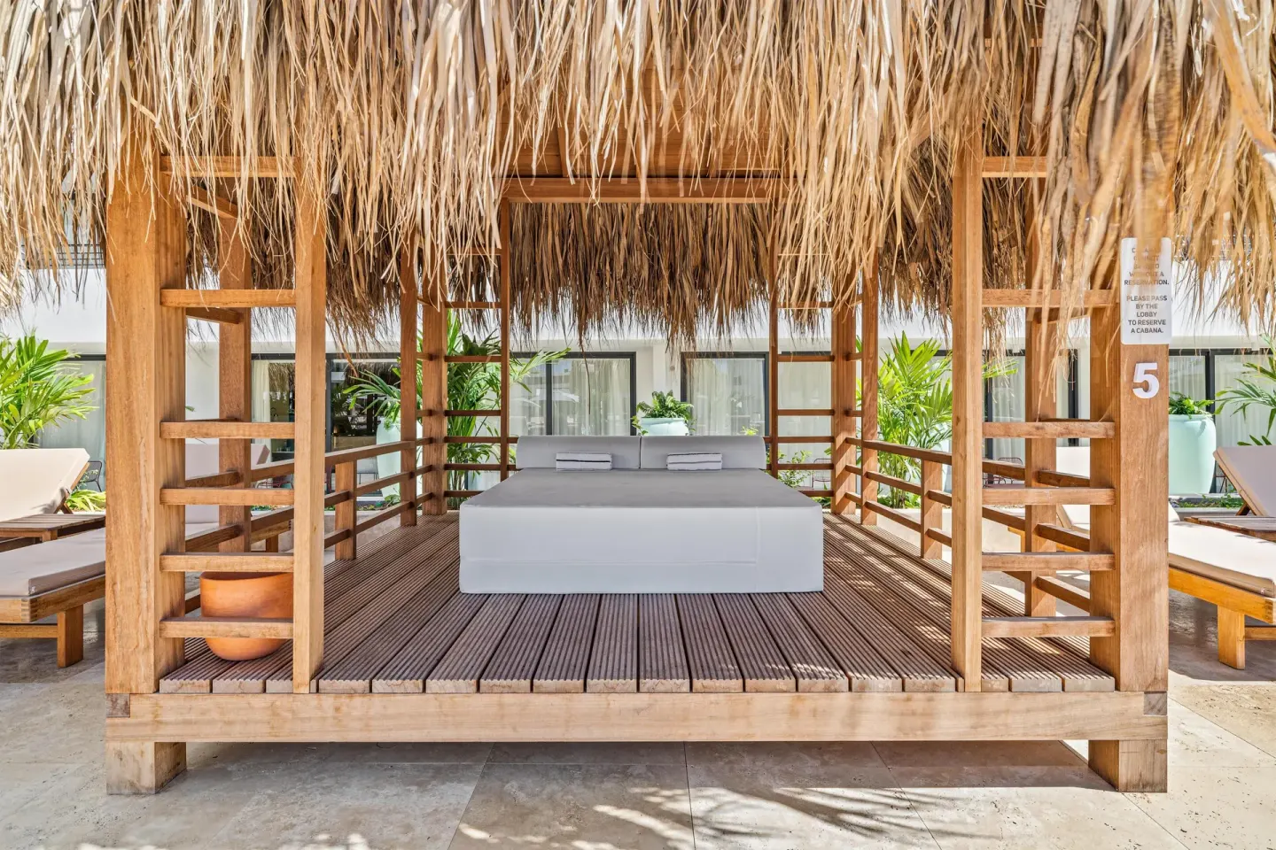 Thatched cabana daybed with pillows at The Rif at Mangrove Beach Corendon Curacao, Curio.