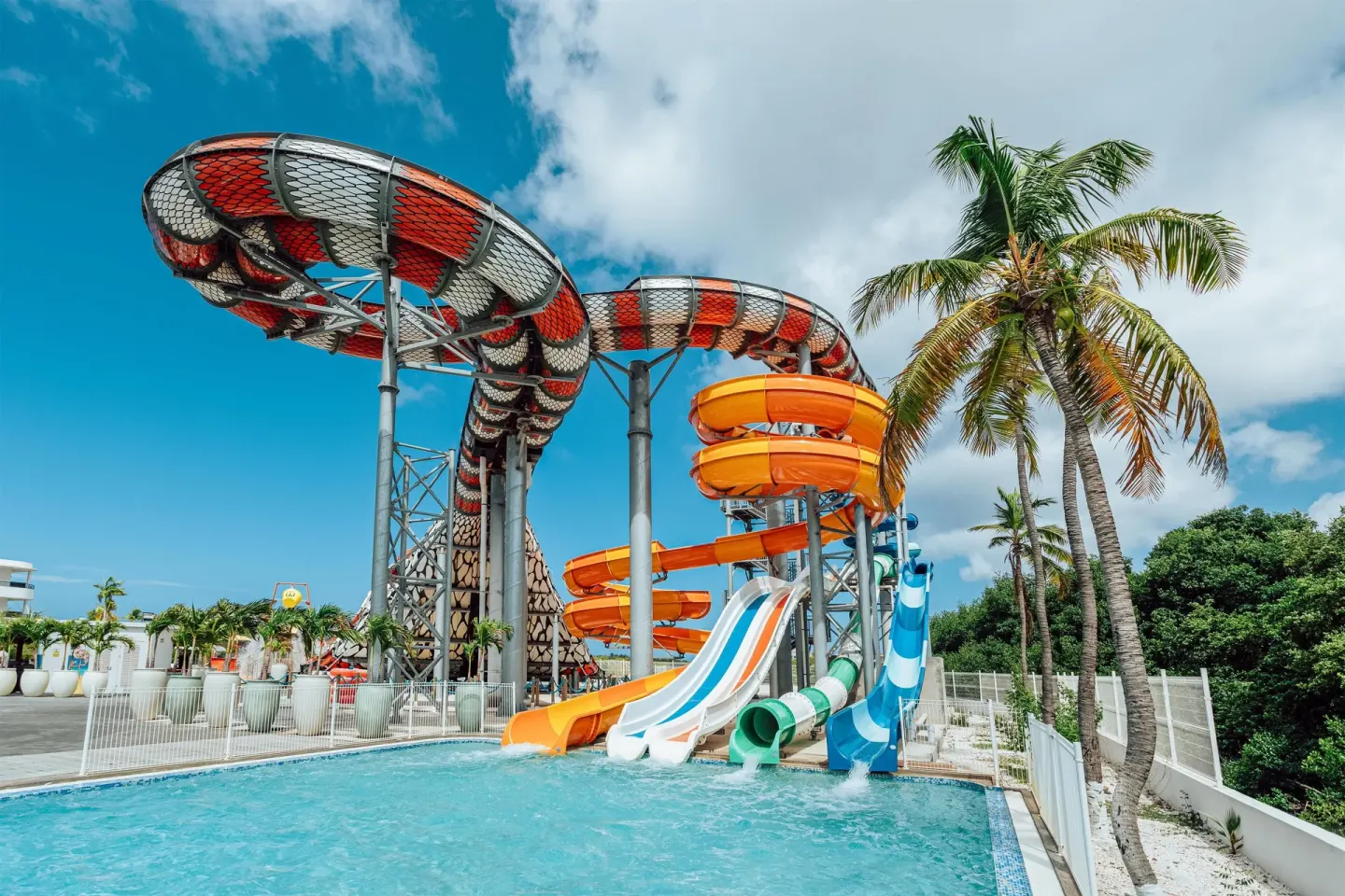 Colorful water slides ending in a pool at The Rif at Mangrove Beach Corendon Curacao, Curio.