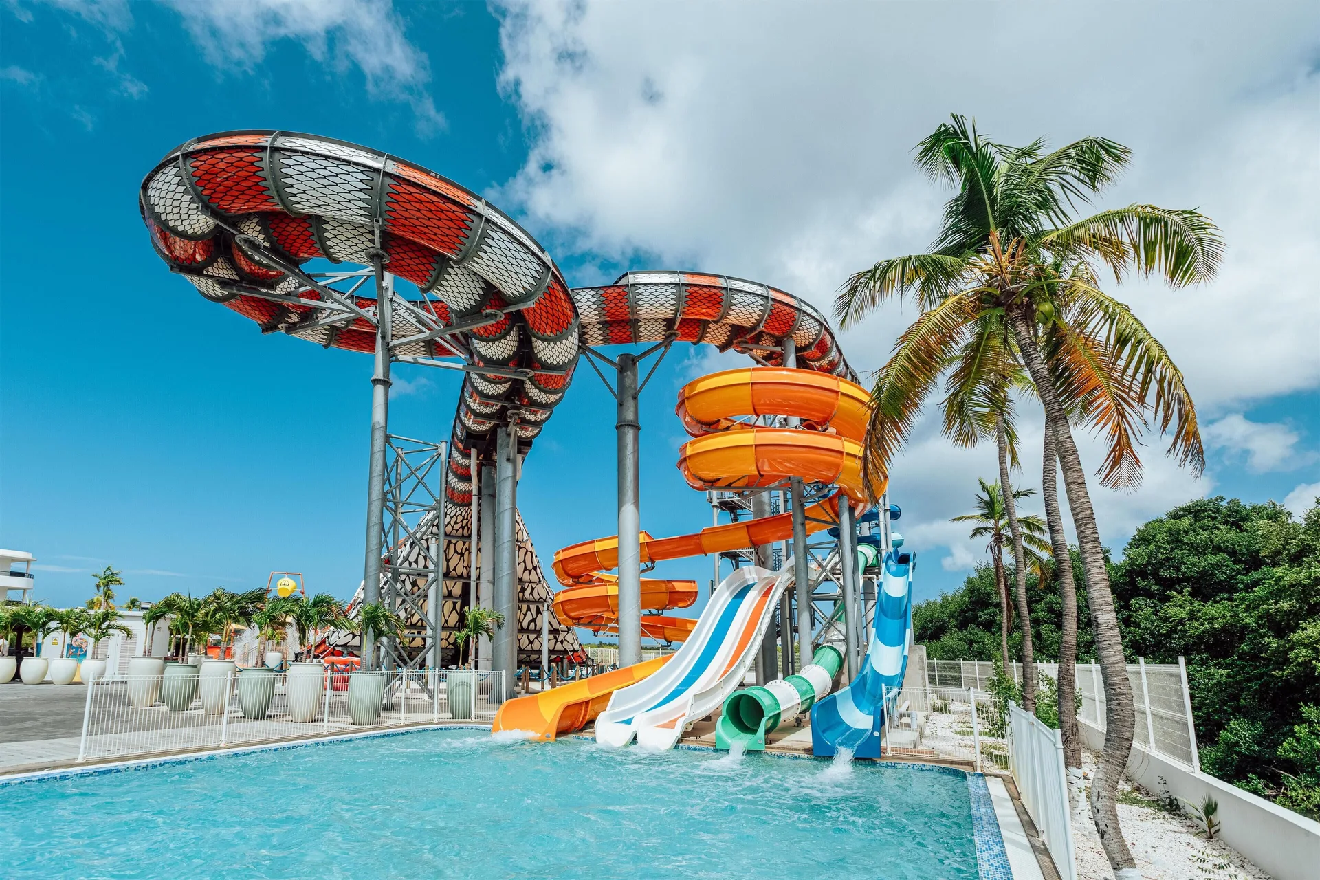 Colorful water slides ending in a pool at The Rif at Mangrove Beach Corendon Curacao, Curio.