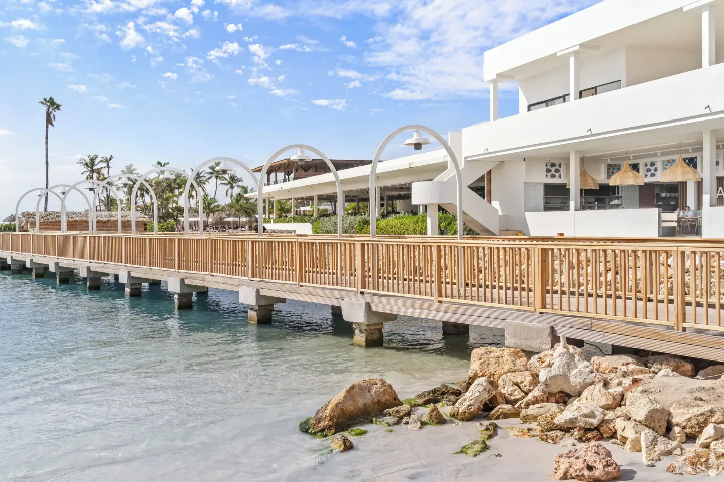 Wooden bridge over clear water at The Rif at Mangrove Beach Corendon Curacao, Curio.