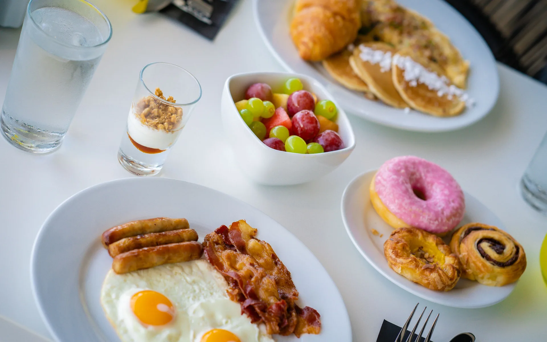 Breakfast plates with eggs, pastries, fruit and yogurt at The Rif at Mangrove Beach Corendon Curacao, Curio.