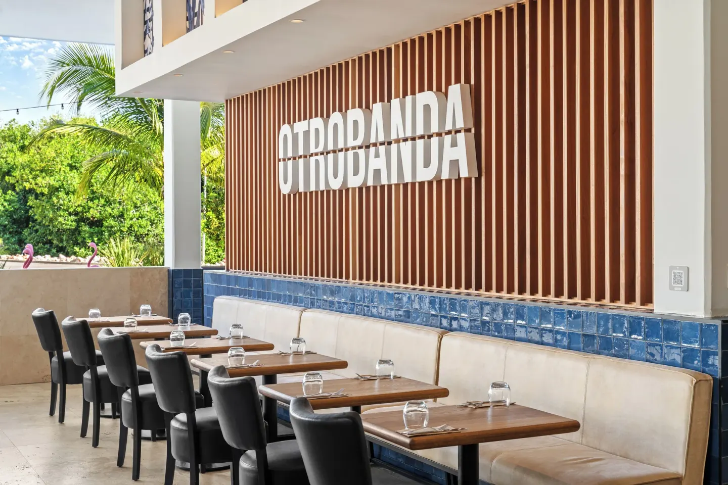 Otrobanda restaurant seating and wall sign at The Rif at Mangrove Beach Corendon Curacao, Curio.