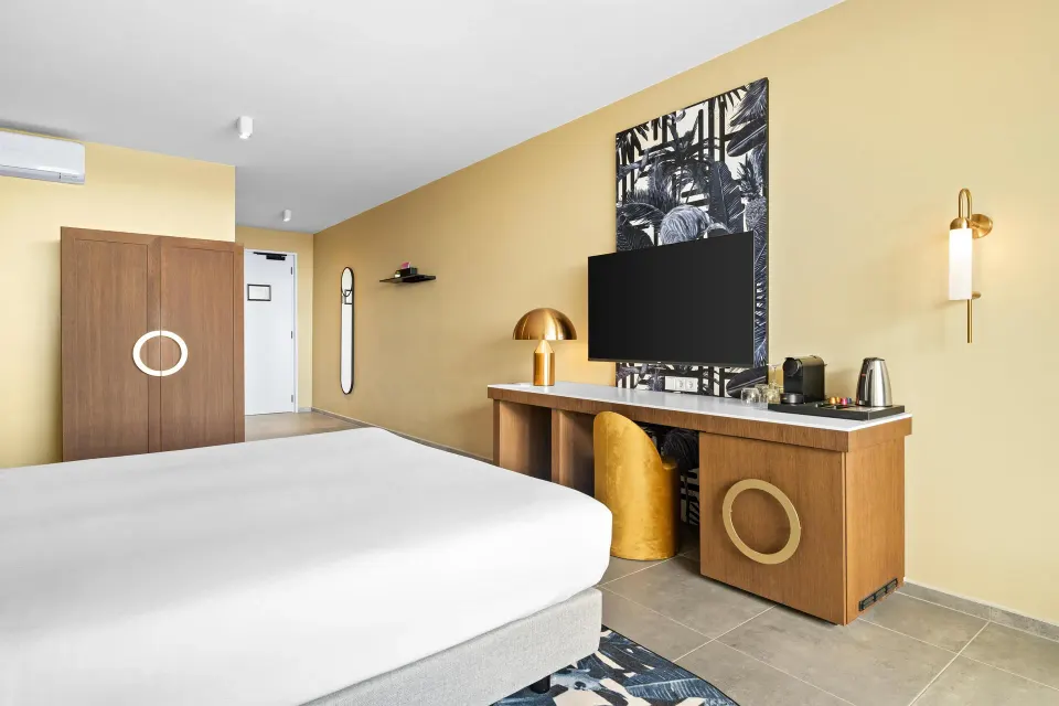 Deluxe Ocean View room with king bed, TV wall, and desk at The Rif at Mangrove Beach Corendon Curacao, Curio.
