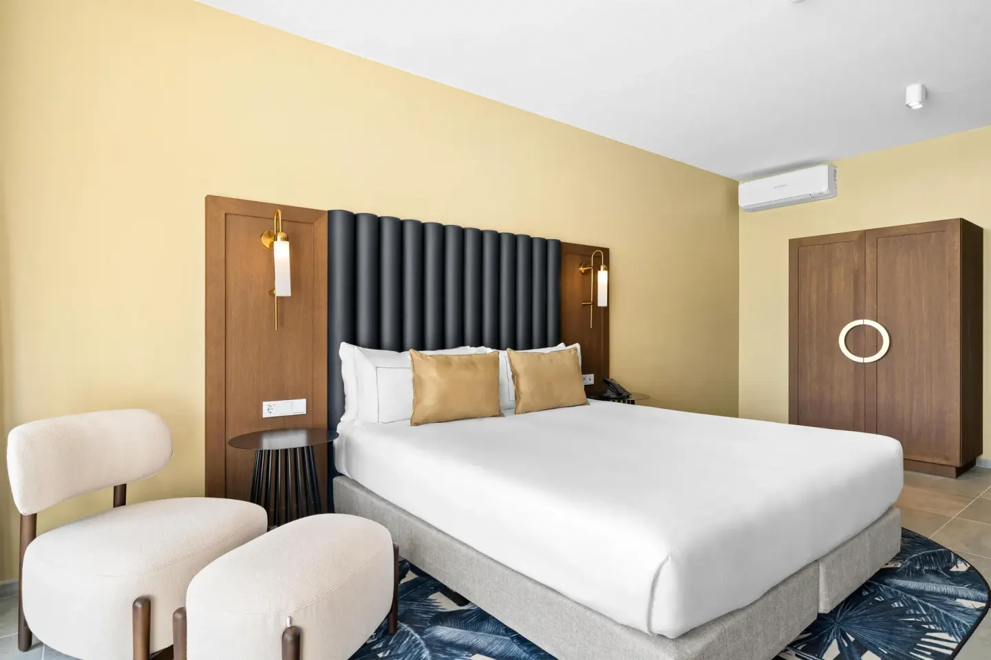 Deluxe Ocean View king room with lounge chair and wardrobe at The Rif at Mangrove Beach Corendon Curacao, Curio.