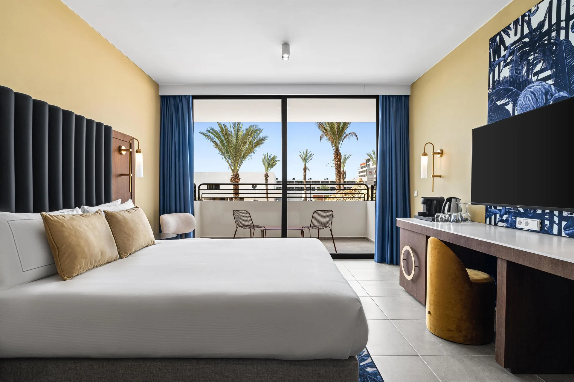 Deluxe Swim Up Room at The Rif at Mangrove Beach with king bed, balcony, and direct pool access in Curaçao.