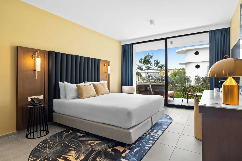 Deluxe Room king bed and terrace at The Rif at Mangrove Beach Corendon Curacao, Curio.