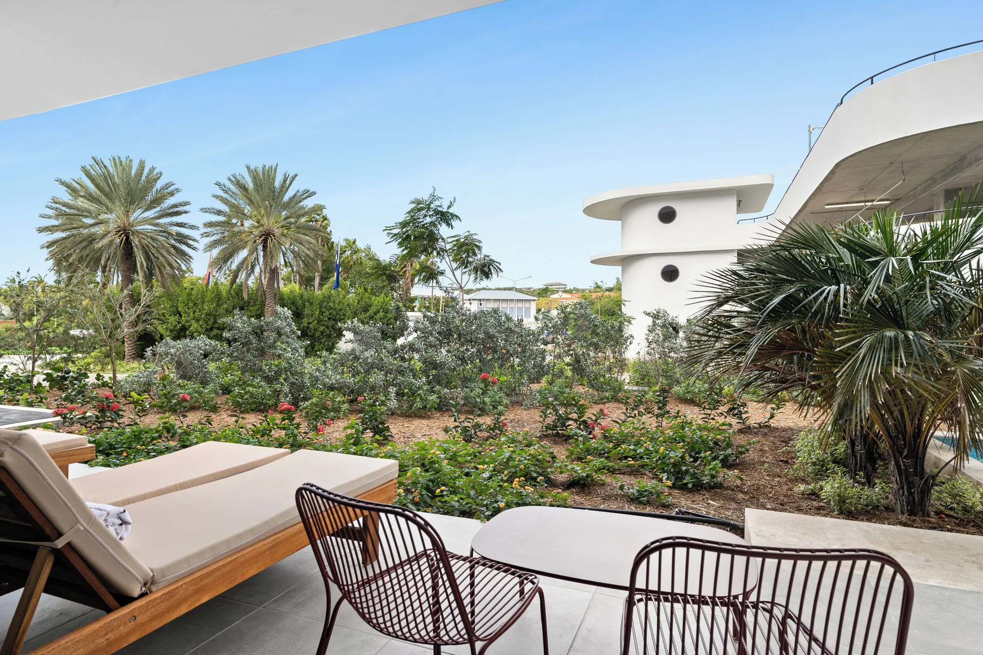 Deluxe Room terrace with lounge chair and garden view at The Rif at Mangrove Beach Corendon Curacao, Curio.