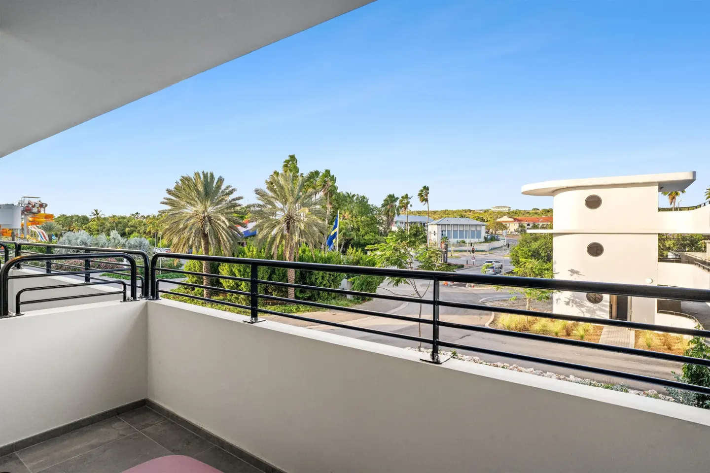 Deluxe Room balcony view with palms at The Rif at Mangrove Beach Corendon Curacao, Curio.