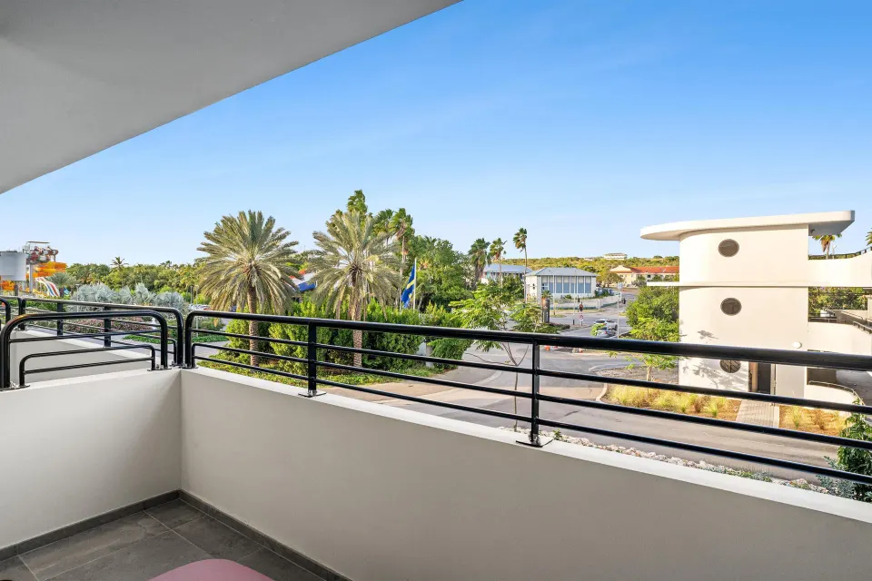 Deluxe Room balcony view with palms at The Rif at Mangrove Beach Corendon Curacao, Curio.