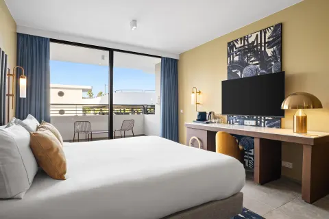 Deluxe Room with king bed, desk and balcony at The Rif at Mangrove Beach Corendon Curacao, Curio.