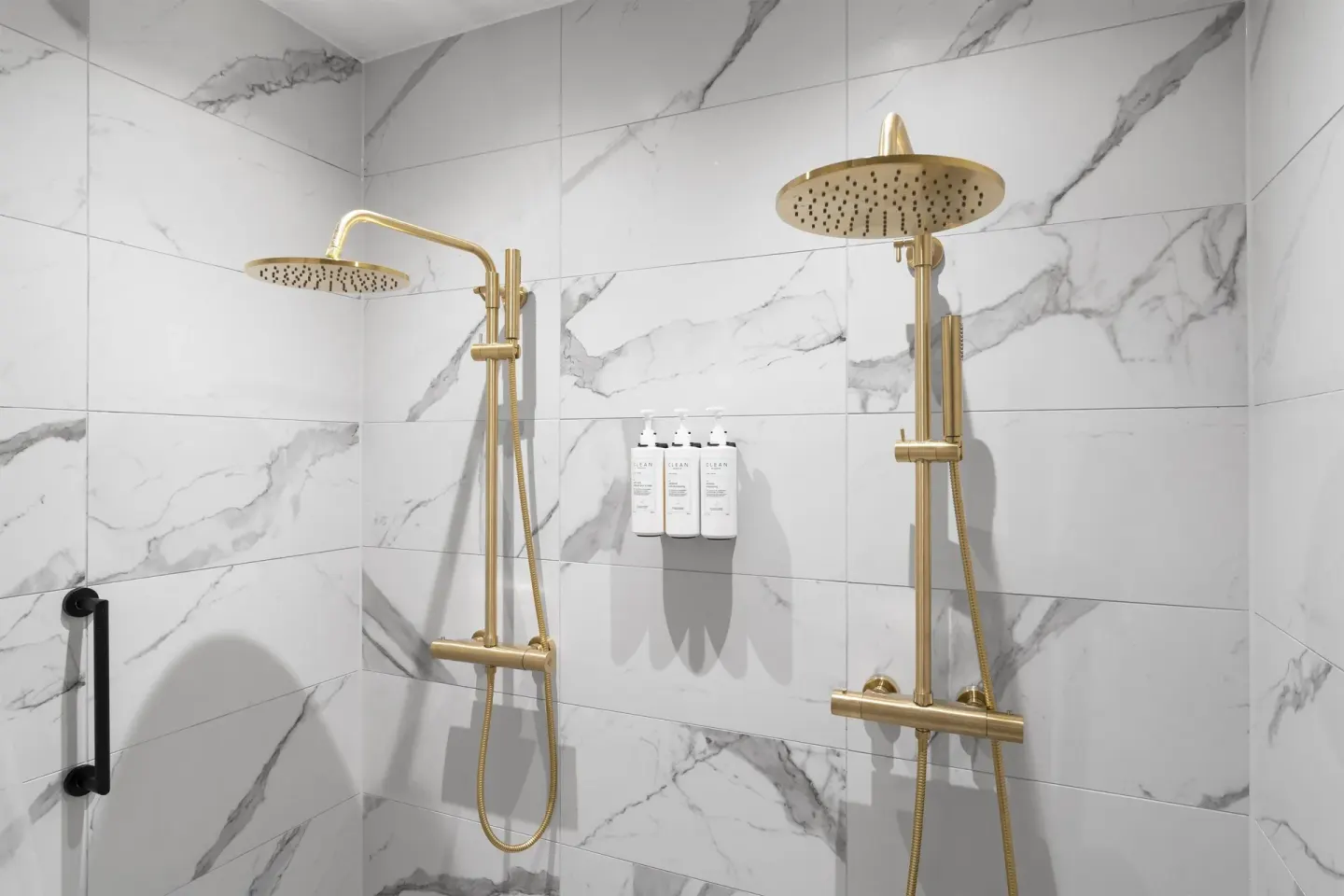 Deluxe Room walk-in shower with dual gold-tone rain heads at The Rif at Mangrove Beach Corendon Curacao, Curio.
