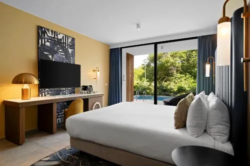 Deluxe Swim Up Room with king bed and terrace pool at The Rif at Mangrove Beach Corendon Curacao, Curio.