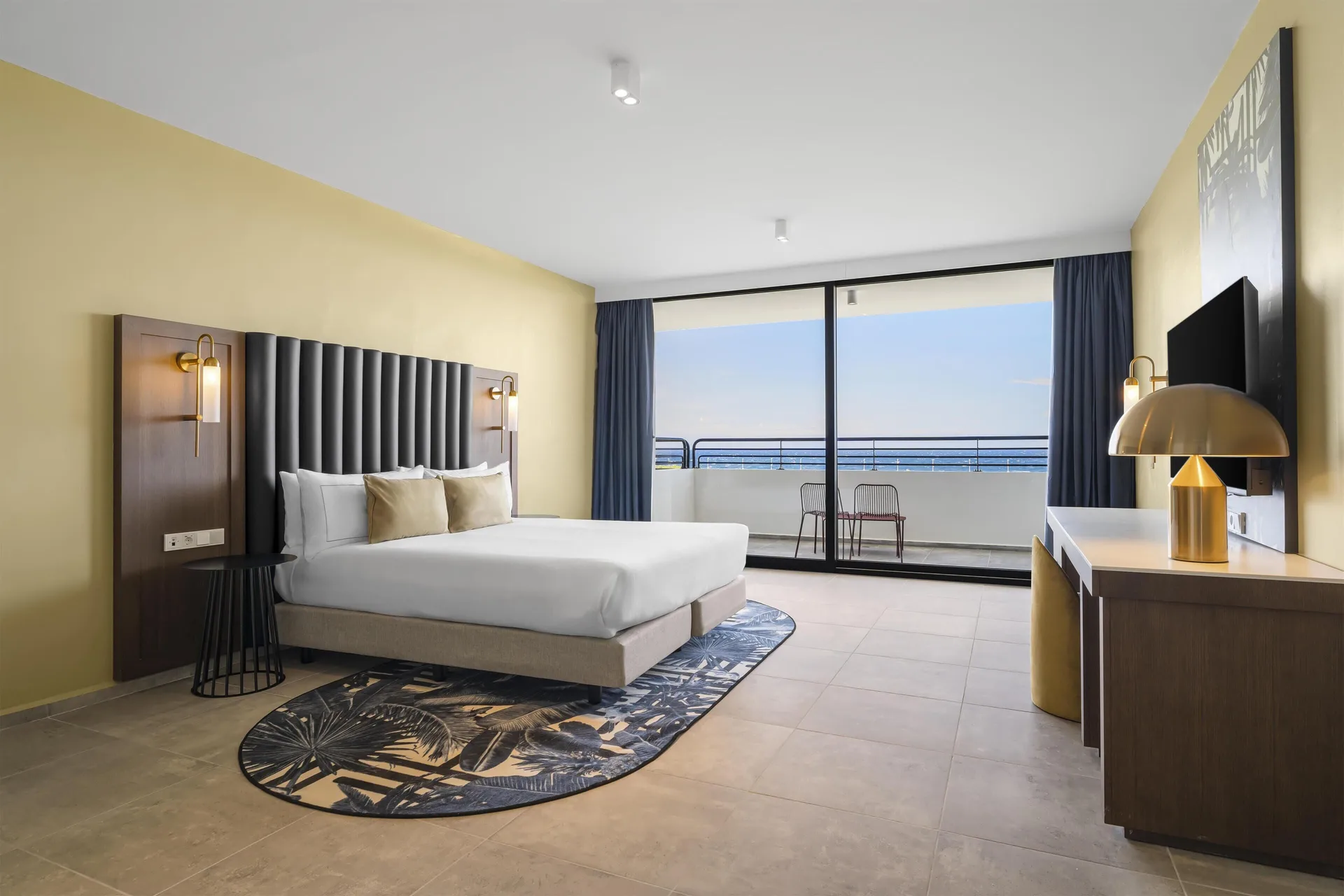 King bedroom with balcony seating at The Rif at Mangrove Beach Corendon Curacao, Curio.