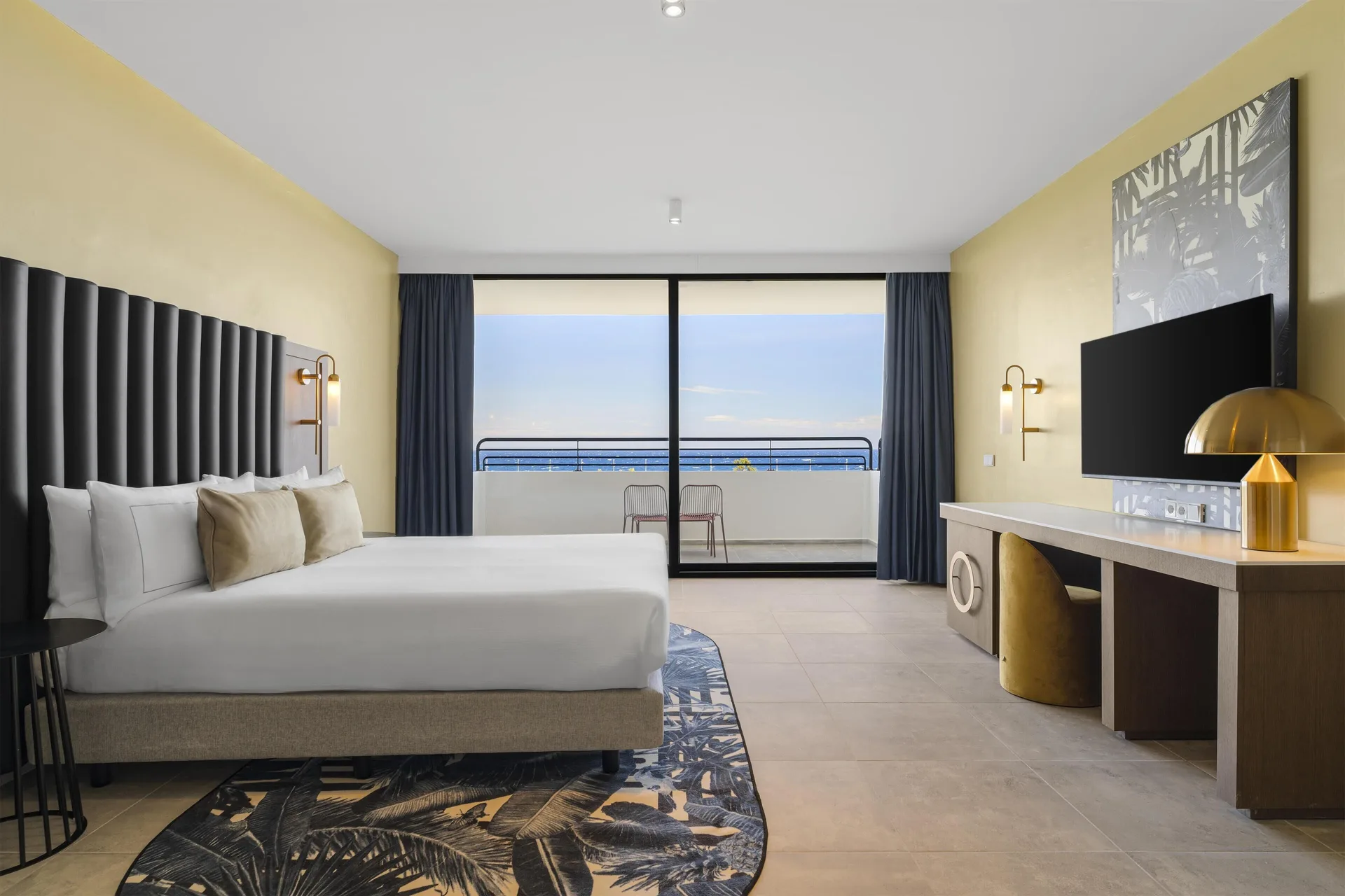 One-bedroom suite with king bed and balcony at The Rif at Mangrove Beach Corendon Curacao, Curio.