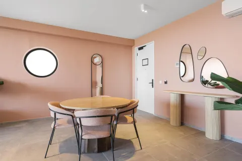 Dining nook with round table and mirrors in a Superior Suite at The Rif at Mangrove Beach Corendon Curacao, Curio.