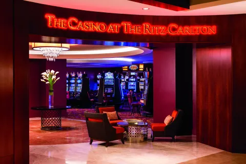 Casino entrance with red sign and slot machines at The Ritz-Carlton, Aruba.
