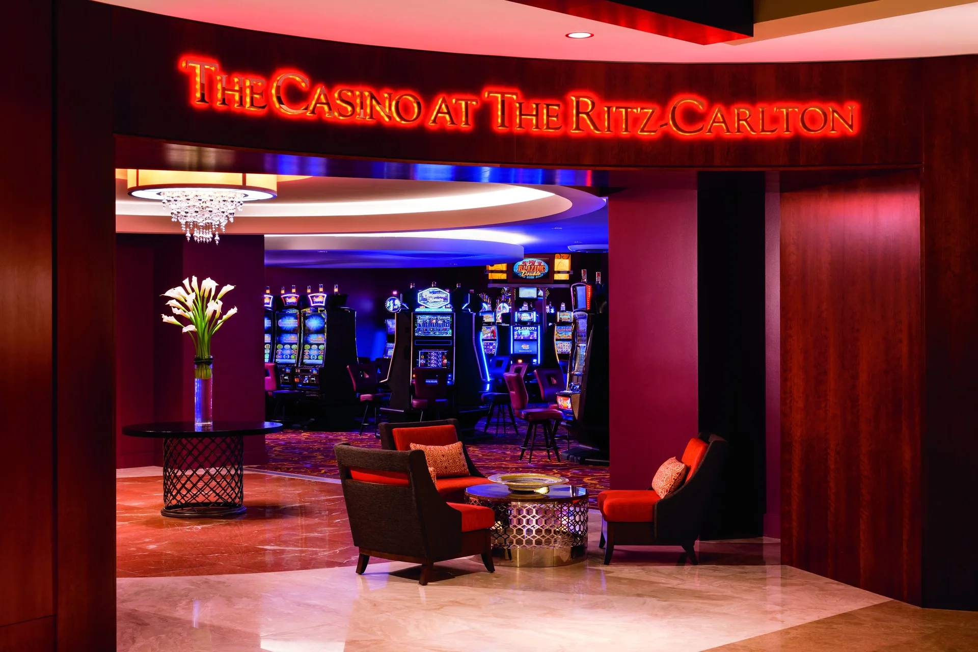 Casino entrance with red sign and slot machines at The Ritz-Carlton, Aruba.
