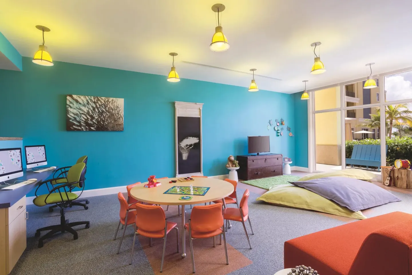 Colorful children’s activity room with computers and play table at The Ritz-Carlton, Aruba.