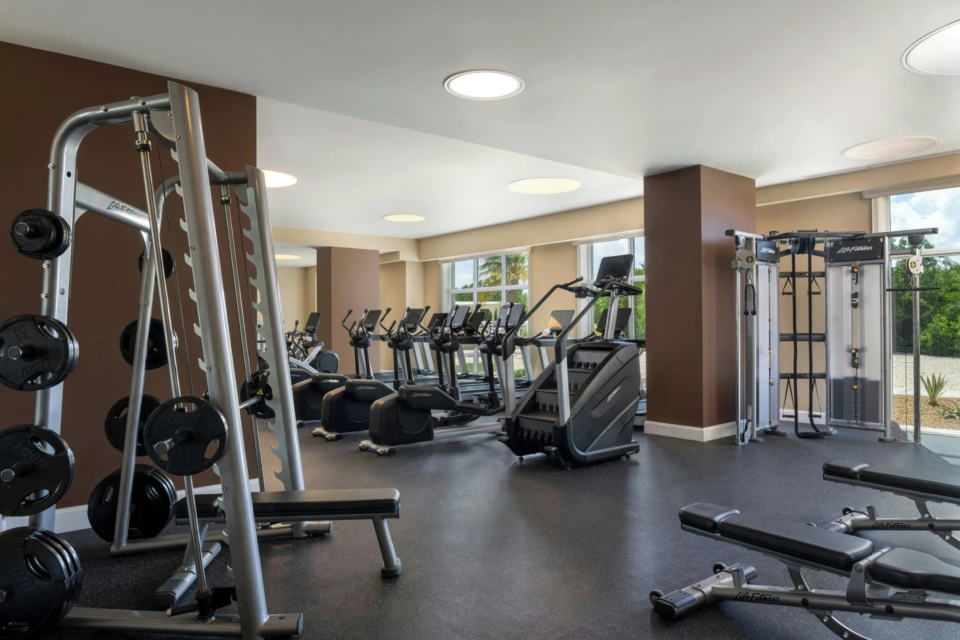 Fitness center with treadmills, weight plates, and strength equipment at The Ritz-Carlton, Aruba.