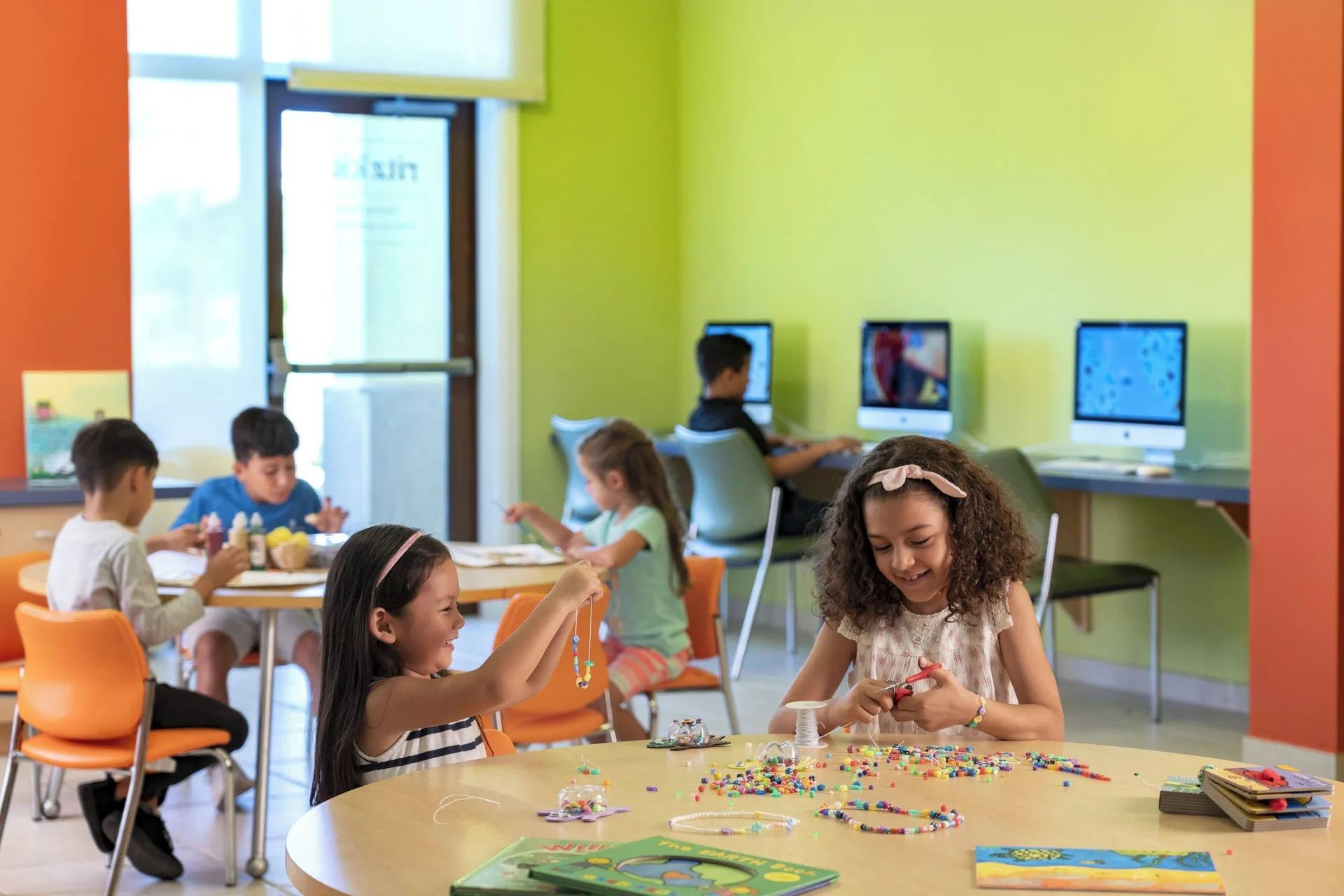 Children making crafts in a colorful activity room at The Ritz-Carlton, Aruba.