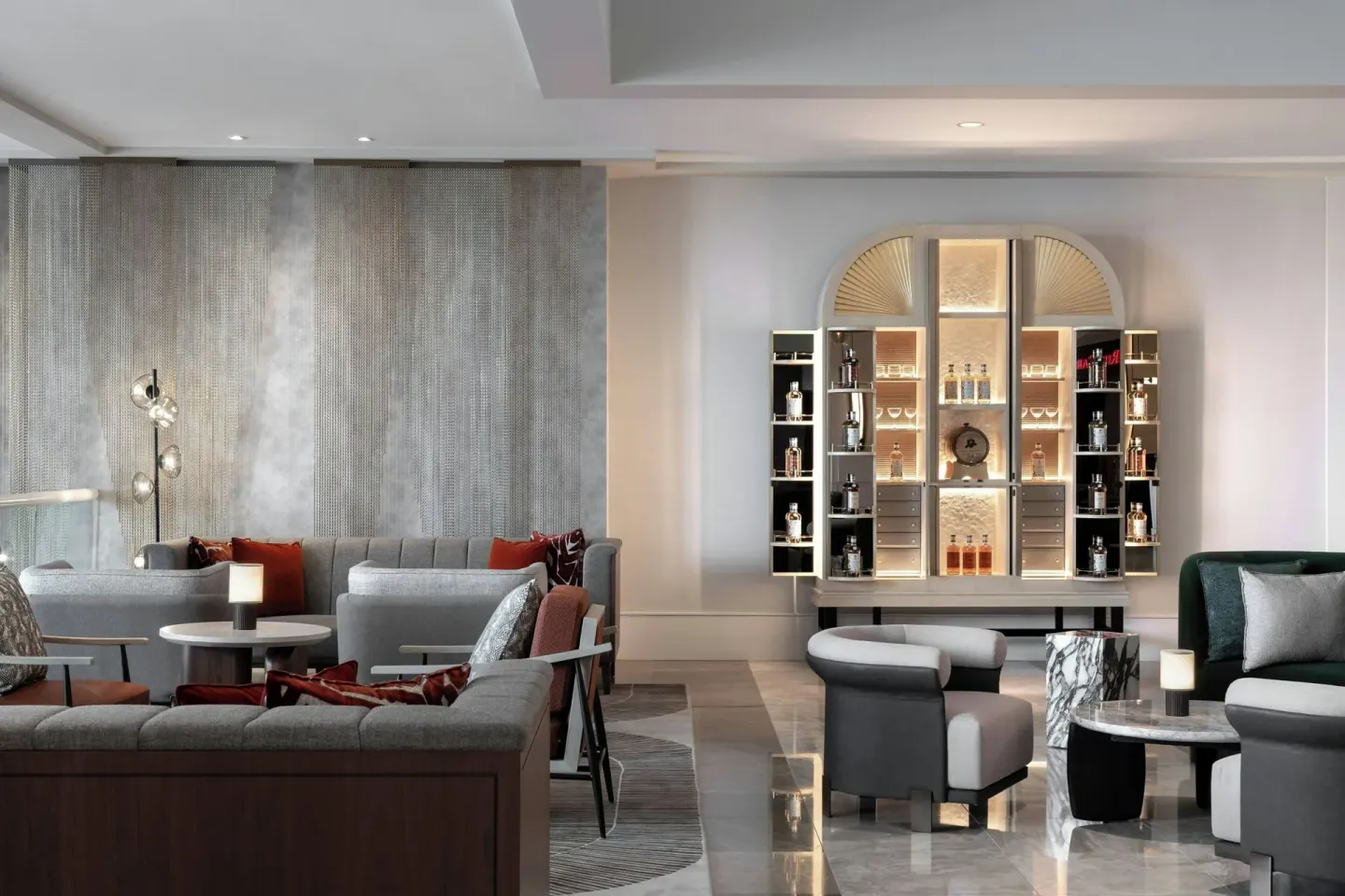 Lobby lounge seating and illuminated bottle display at The Ritz-Carlton, Aruba.