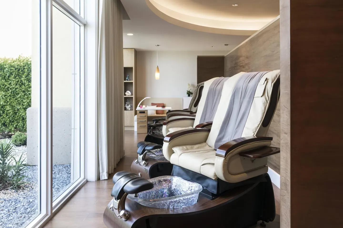 Spa pedicure chairs beside floor-to-ceiling windows at The Ritz-Carlton, Aruba.