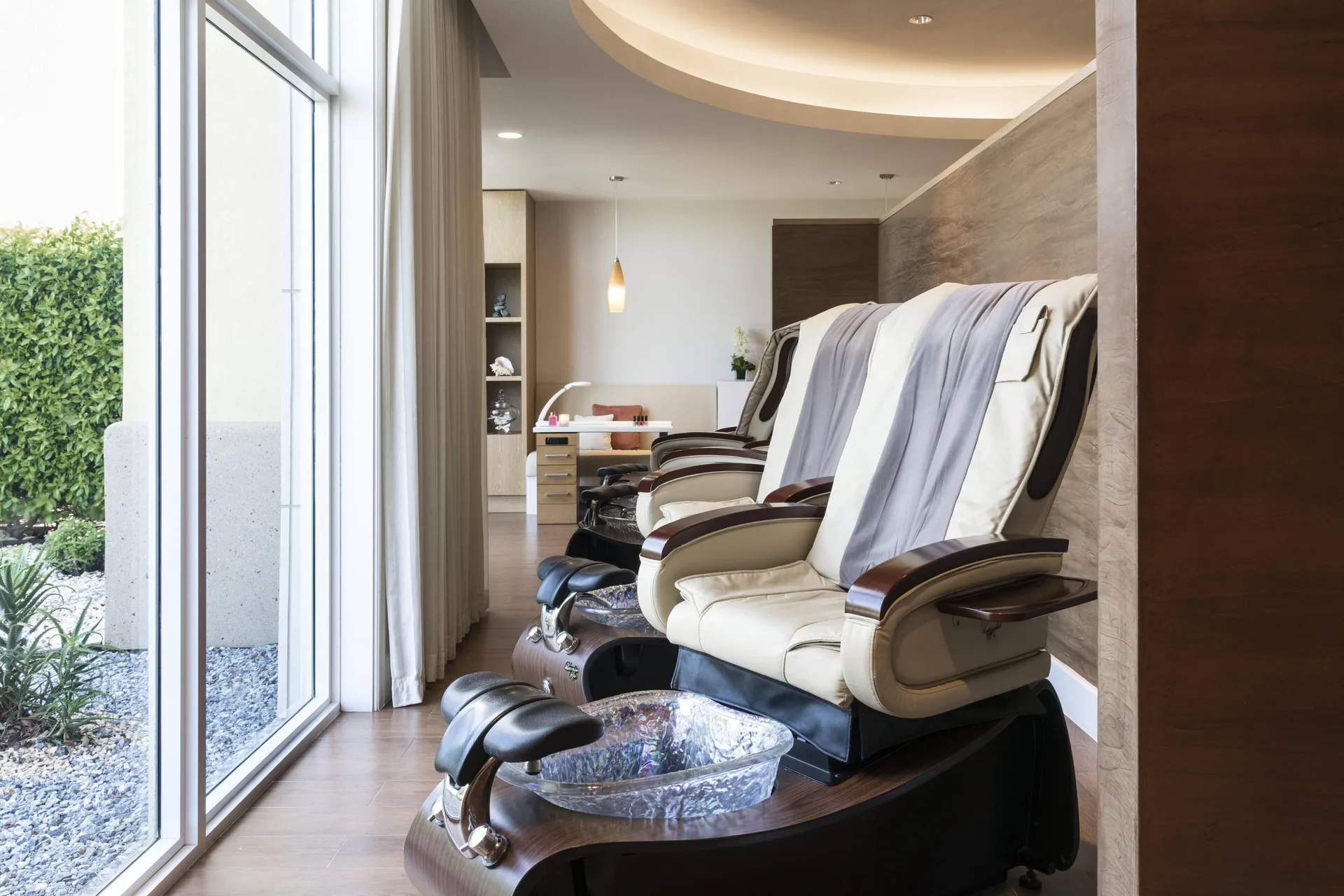 Spa pedicure chairs beside floor-to-ceiling windows at The Ritz-Carlton, Aruba.