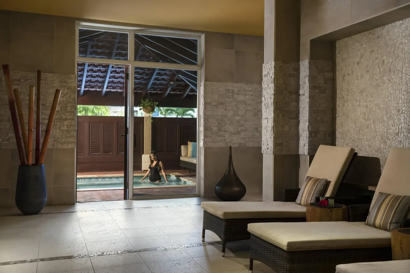 Spa lounge chairs beside a pool cabana at The Ritz-Carlton, Aruba.