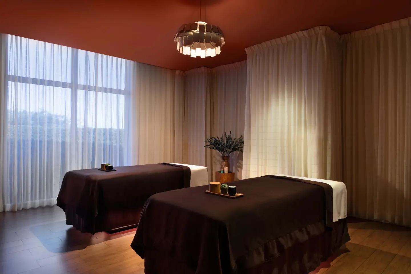 Two spa treatment tables in a curtained room at The Ritz-Carlton, Aruba.