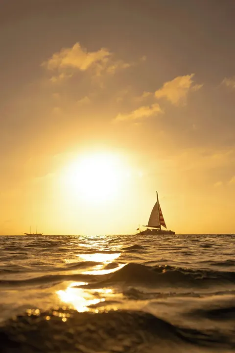 Sailboat on the ocean at sunset near The Ritz-Carlton, Aruba.