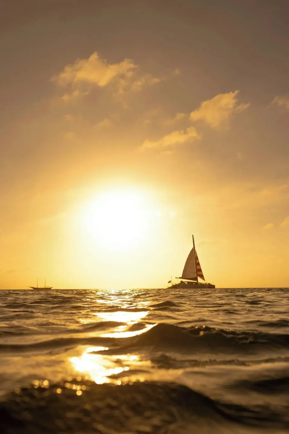 Sailboat on the ocean at sunset near The Ritz-Carlton, Aruba.